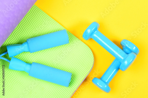 Set of sports equipment holding blue skipping rope handles