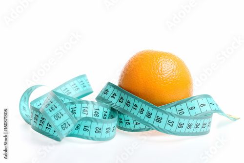 Concept of healthy diet food with orange and measuring tape
