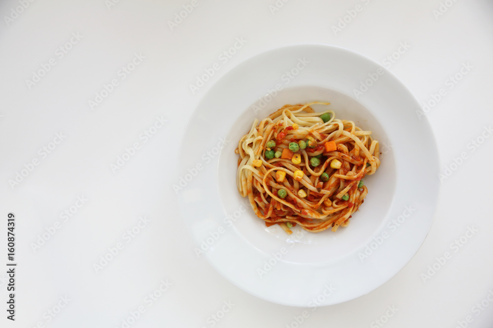 Fettuccine pasta in tomato sauce isolated in white background Fettuccine pasta in tomato sauce isolated in white background