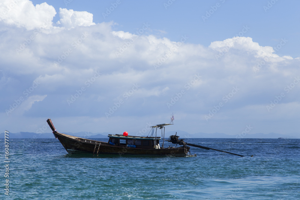 The turquoise sea with beautiful sky and clouds and the boat tour to Andaman Sea Thailand.