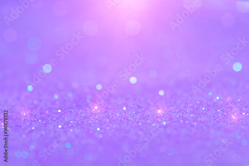 Soft violet or purple bokeh light is the soft blurred circles of light white and light purple . Winter Christmas and valentine background wallpaper concept