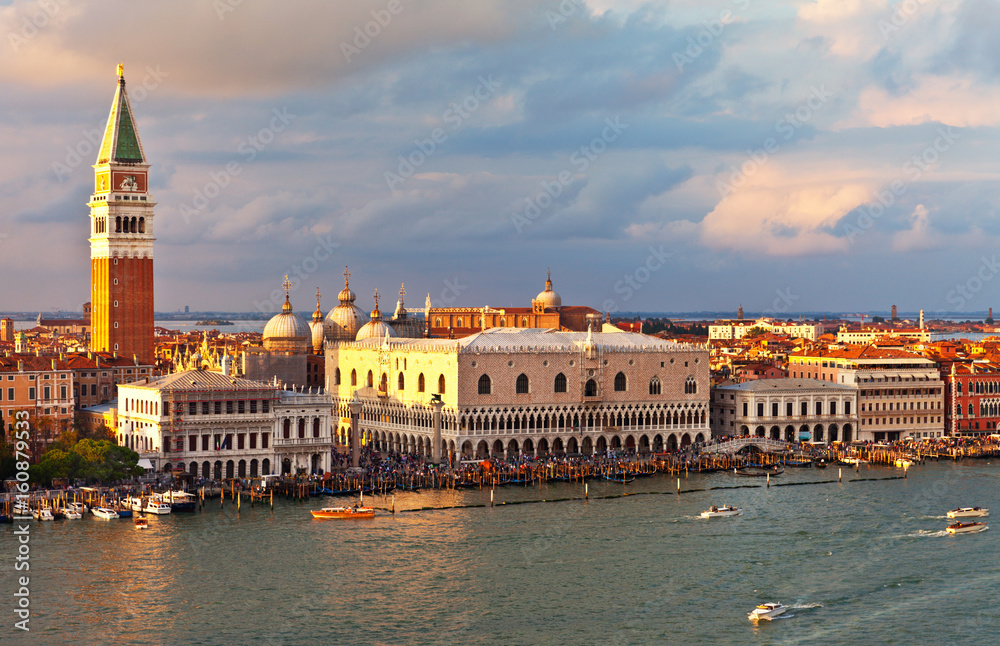 Venice. Top view of the Piazzetta San Marco, the Doge's Palace and Bell Tower Companile at sunset. Many tourists on the promenade of San Marco