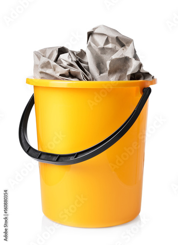 Yellow bucket with paper isolated on white background