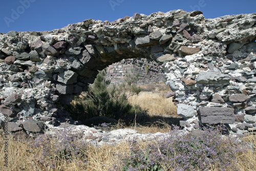 uin of a castle at Dry and withered landscape at Lesbos Greece at the coast. Mediterranean Sea. Arch. Rocks. photo