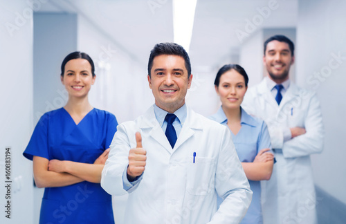 medics or doctors at hospital showing thumbs up