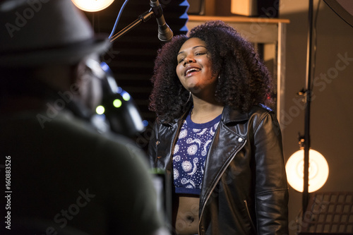 Valokuva Black female vocalist working with her producer in a music studio
