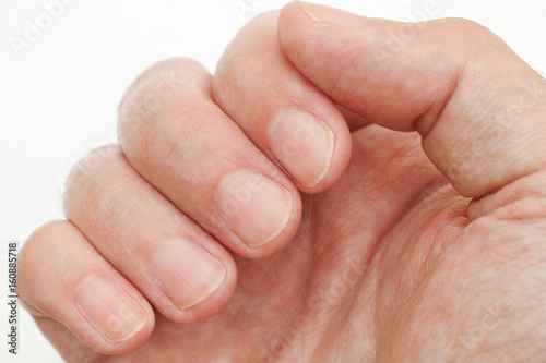 Man looking at his finger nails