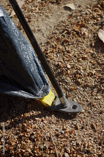 Securing a camping tend to the ground photo
