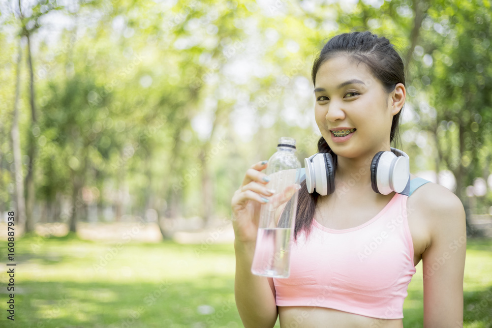 beautiful sport girl drinking water after jogging , sport concept