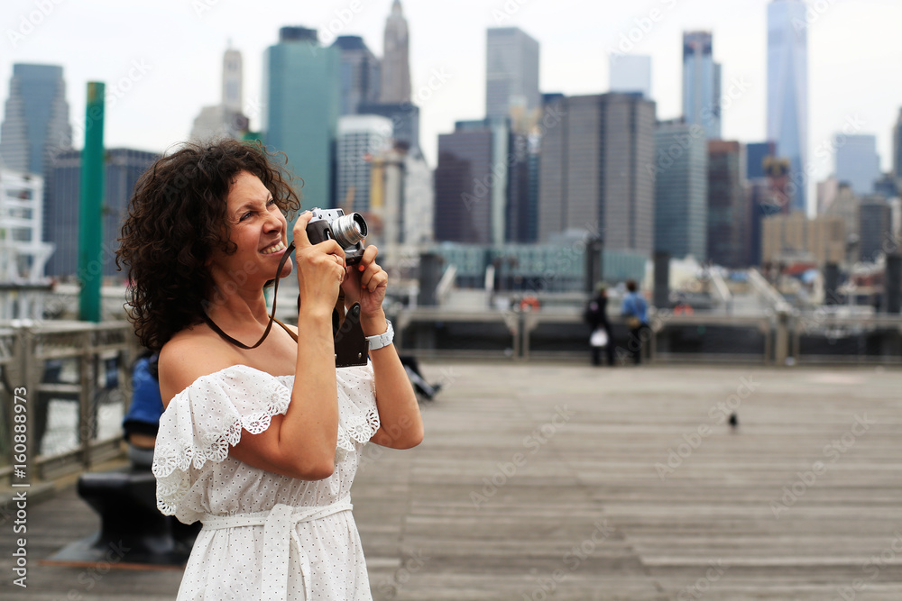 Young beautiful woman photographing in new York