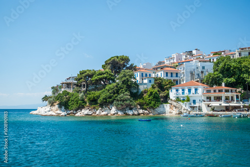 White house with blue windows on the island of Skiathos, a feature of Greek culture © Irma