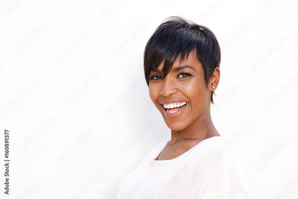 Close up stylish young black woman laughing against white background