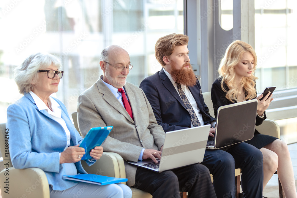 Business team sitting in a row Business team sitting in a row
