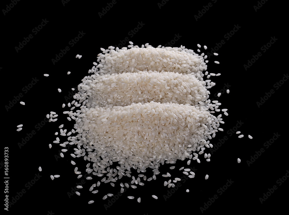 White rice pile isolated on a black background