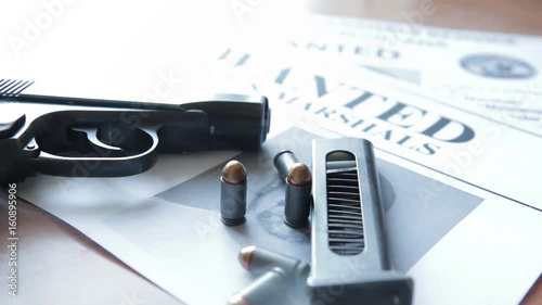 An announcement about the search for a criminal on the table of the bounty hunter, a combat pistol, cartridges