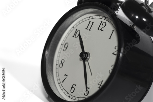 Black, vintage alarm clock with qwhite background