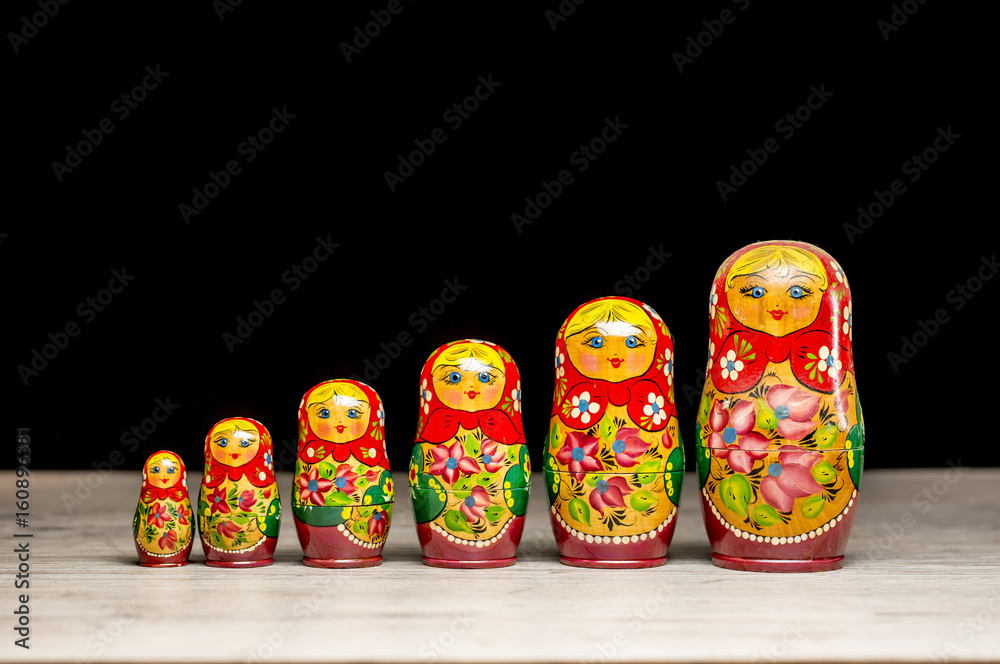 Vintage Russian matryoshka nesting dolls lined on table