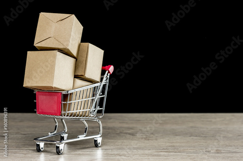 Close up shot of four carton packages in shopping trolley