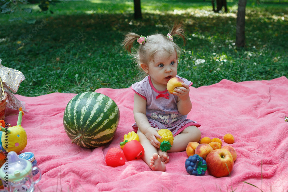 Fototapeta premium Happy family on picnic in the Park, eat watermelon, fruits