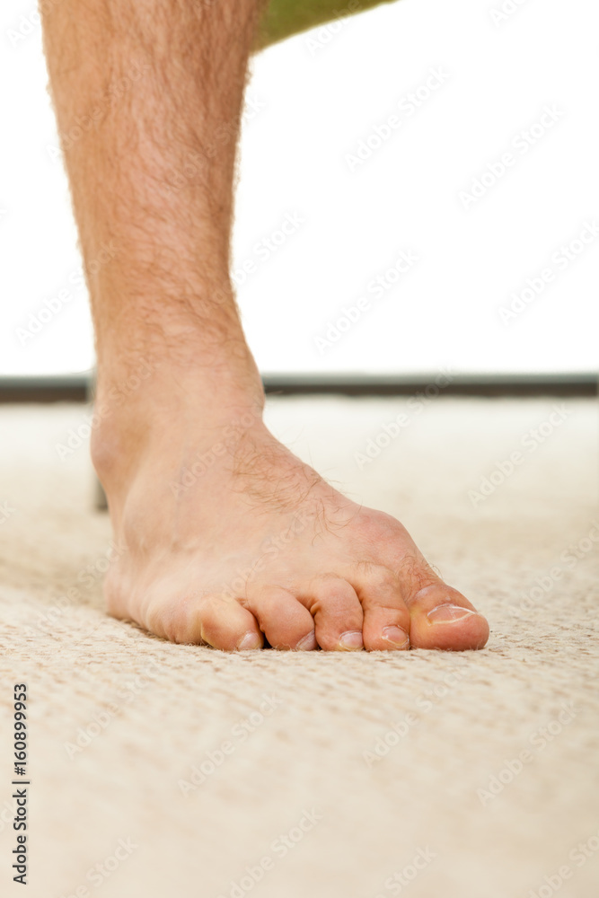 Closeup of man foot standing on carpet Closeup of man foot standing on carpet