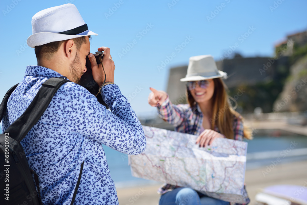 Tourists taking photo in the city at the sea.