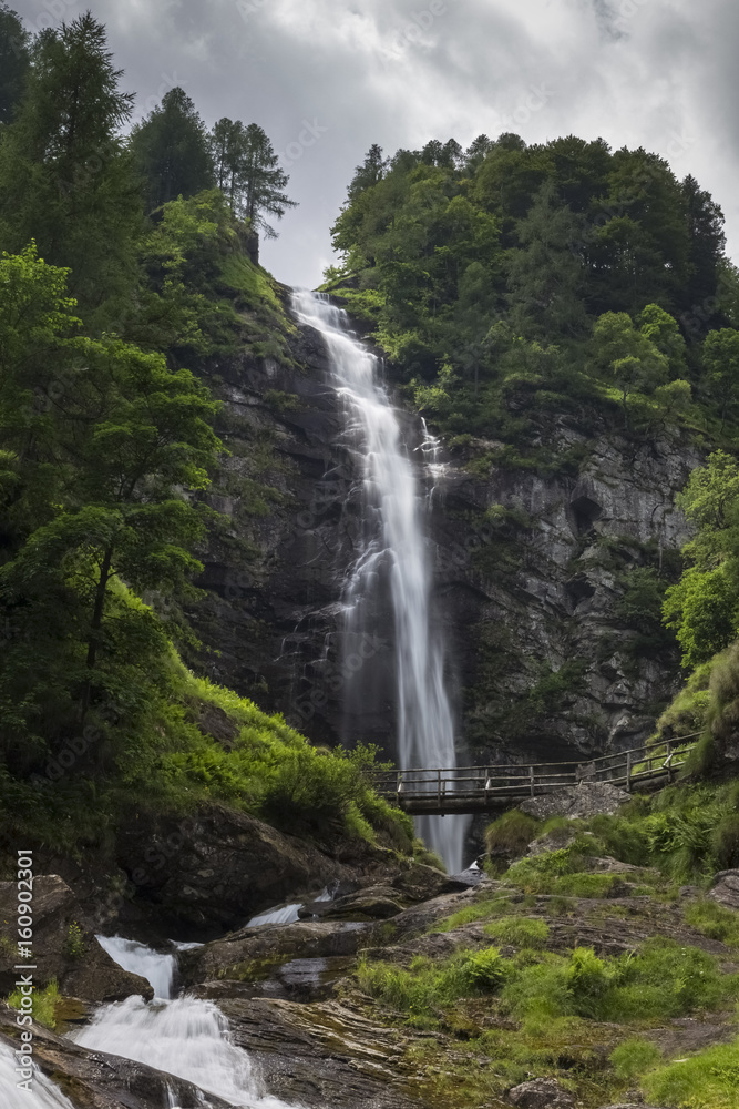 Wooden bridge under the Cascata della Froda, Sonogno, Valle Verzasca, Canton Ticino, Switzerland. Wooden bridge under the Cascata della Froda, Sonogno, Valle Verzasca, Canton Ticino, Switzerland.