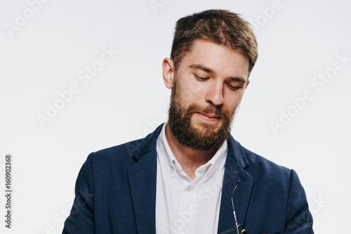 Business man looking down, business man with a beard, business man on a light background portrait
