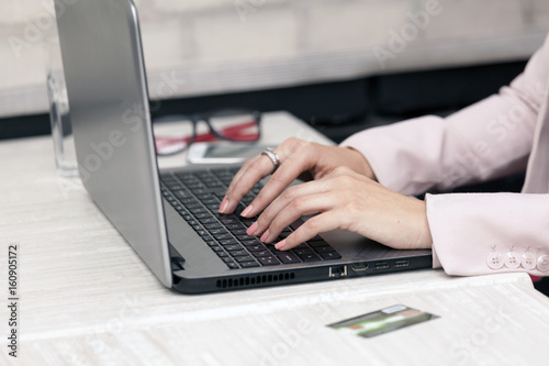 Female hand typing text on the keyboard