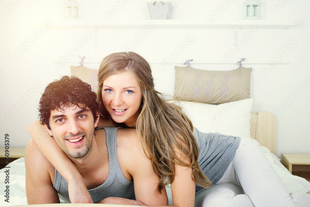 Couple laughing in bed and they are happy Couple laughing in bed and they are happy