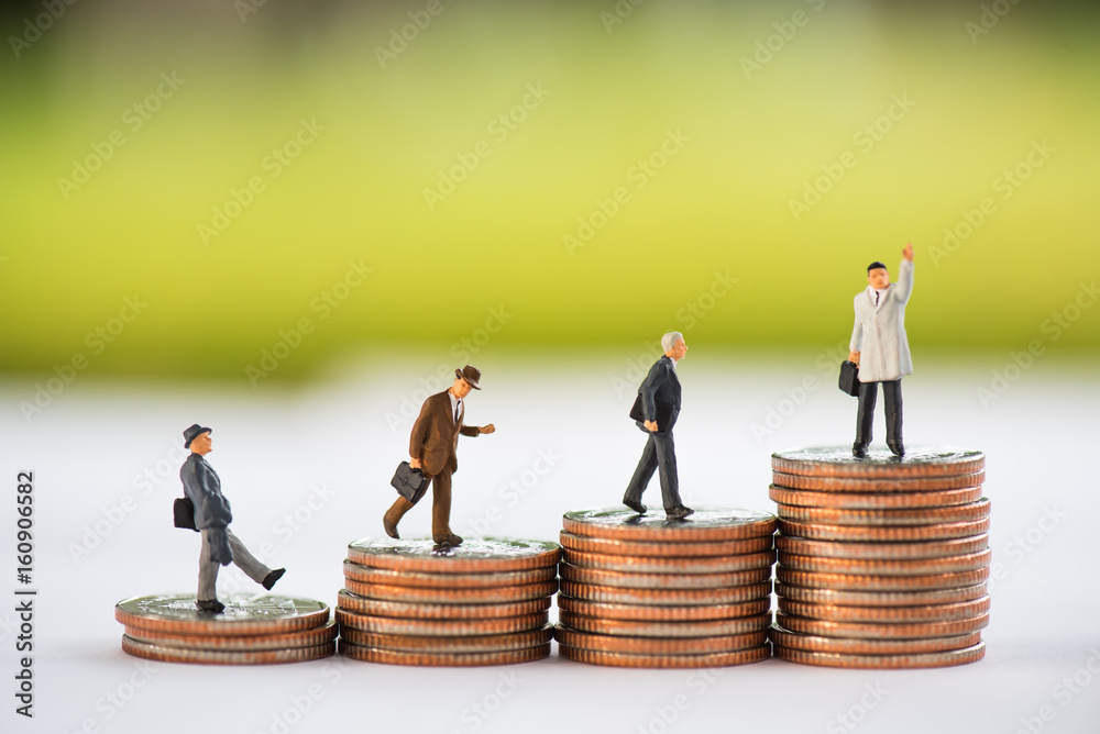 Miniature people: Businessman on coin stacks using for business growth concept Miniature people: Businessman on coin stacks using for business growth concept