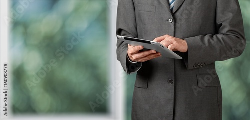 Businessman working on digital tablet.