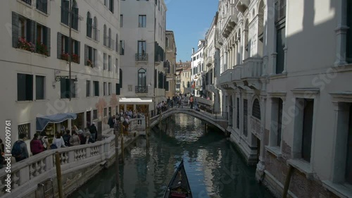 Romantic tour in gondola, rowed by a gondolier in the venice canal. photo