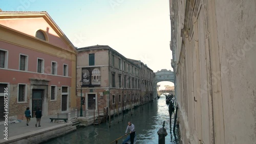 Romantic tour in gondola, rowed by a gondolier in the venice canal. photo