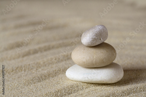 Pile of balanced stones on sand