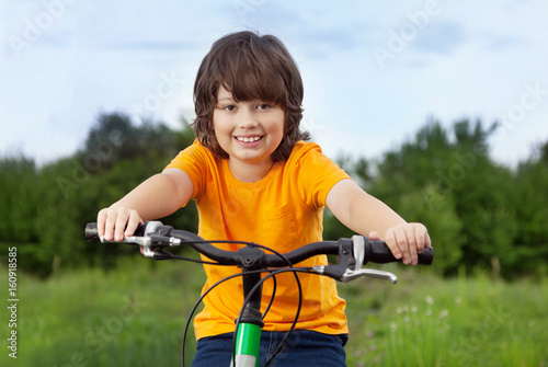 happy boy ride bikes outdoors
