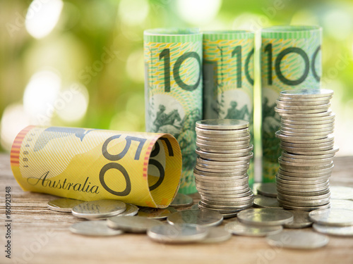 Australia banknote and stacks of coins.