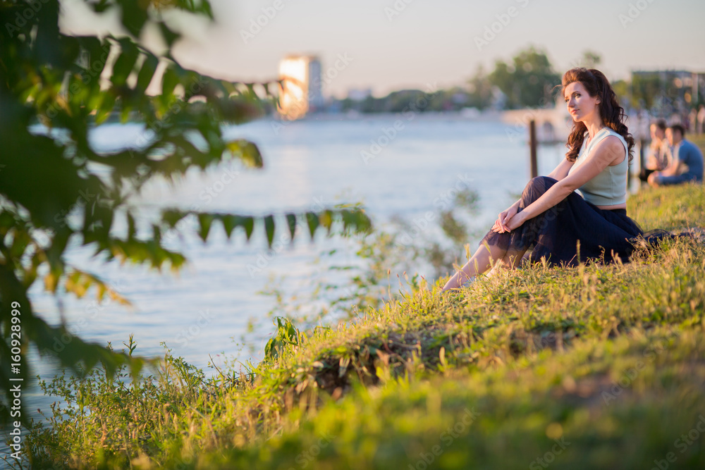 young woman on the river bank