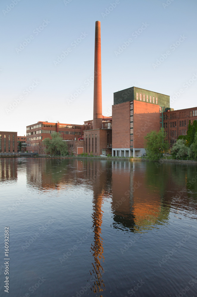 Obraz premium Tampere city old industrial buildings in Tammerkoski river, Finland.