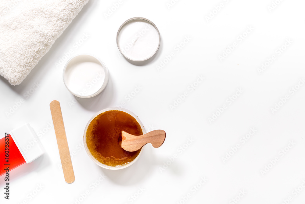 Preparing for depilation with wax on white background top view copyspace Preparing for depilation with wax on white background top view copyspace