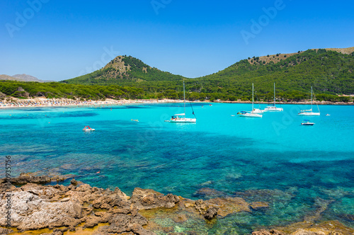 Beautiful beach bay with sailing boats, Majorca island, Spain