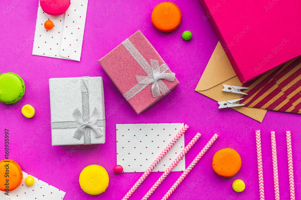 Birthday greeting cards and wrapped gifts on fuchsia background top view Birthday greeting cards and wrapped gifts on fuchsia background top view