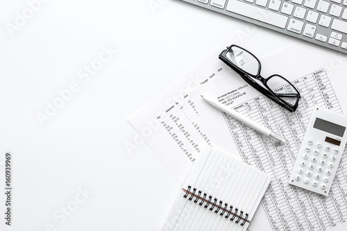 Business report preparing with calculator and glasses on white office background top view mock up photo