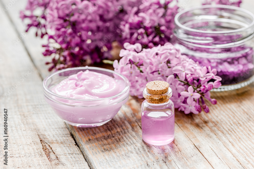 lilac natural cosmetic set for spa with oil wooden table background lilac natural cosmetic set for spa with oil wooden table background