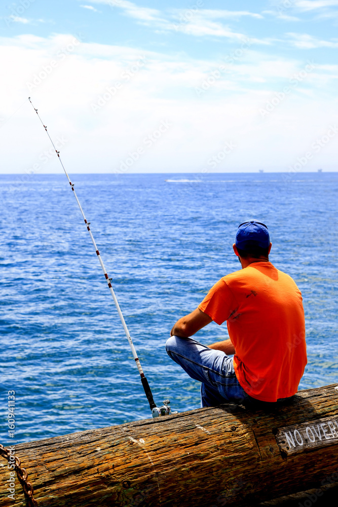 Man angling off Stearns Wharf in Santa Barbara, CA, USA Man angling off Stearns Wharf in Santa Barbara, CA, USA