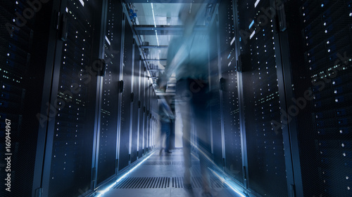 Valokuva Shot of Corridor in Large Data Center Full of Moving and Working People