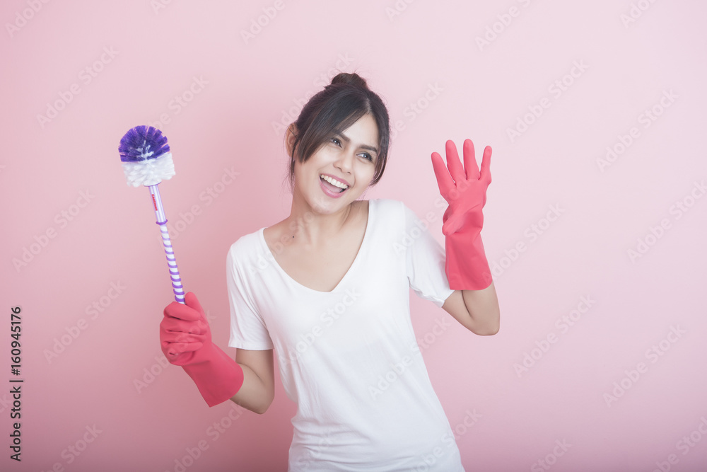 Beautiful asian housewife smiling on pink background Beautiful asian housewife smiling on pink background