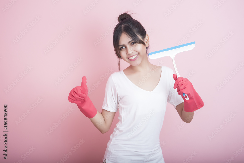 Beautiful asian housewife smiling on pink background Beautiful asian housewife smiling on pink background