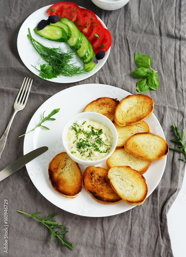 bread toast with garlic cheese sauce on grey background. top view