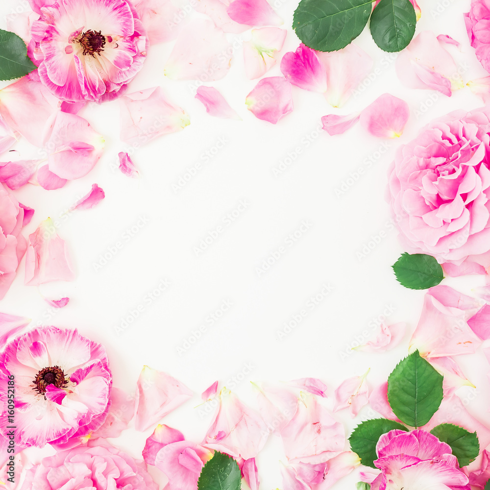 Round floral frame of pink ranunculus flowers, roses, petals and leaves on white background. Floral lifestyle composition. Flat lay, top view.