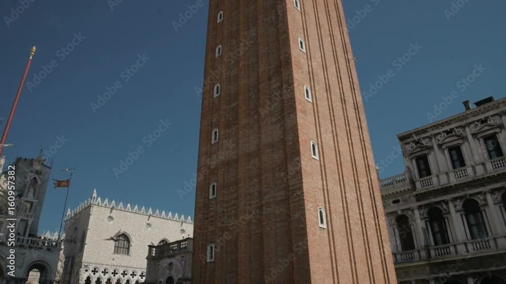 Campanile di Venezia With The Winged Lion In The Background, Located At Piazza San Marco, Italy